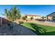 Backyard with a putting green, gravel, seating, and a block fence at 13855 S 181St Ave, Goodyear, AZ 85338