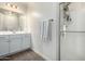 Bathroom features gray cabinets, double sinks, and a glass-enclosed shower at 13855 S 181St Ave, Goodyear, AZ 85338