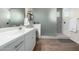 Bathroom featuring a sink and a shower with decorative tiles and a glass door at 13855 S 181St Ave, Goodyear, AZ 85338