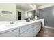 Bathroom featuring a double sink vanity with white countertops and ample storage space at 13855 S 181St Ave, Goodyear, AZ 85338