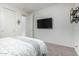 Bright bedroom featuring a bed, a television and carpeted floors at 13855 S 181St Ave, Goodyear, AZ 85338