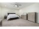 Bedroom with neutral walls, a ceiling fan and carpeted floors, providing a cozy and inviting atmosphere at 13855 S 181St Ave, Goodyear, AZ 85338