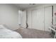 A light-filled bedroom with a closet, and a view into the hall through a partially open door at 13855 S 181St Ave, Goodyear, AZ 85338