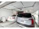 A spacious garage with a white sedan and silver SUV parked inside at 13855 S 181St Ave, Goodyear, AZ 85338