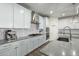 Beautiful kitchen showcasing white cabinets, stainless steel appliances, granite counters, and subway tile backsplash at 13855 S 181St Ave, Goodyear, AZ 85338