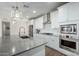 Stylish kitchen with granite countertops, stainless steel appliances and white cabinets at 13855 S 181St Ave, Goodyear, AZ 85338