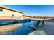 Backyard pool with tiled retaining wall, hardscaped deck, and mountain views at 13855 S 181St Ave, Goodyear, AZ 85338