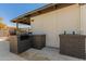 Built-in BBQ and side yard with planters at 1413 N Sunview Pkwy, Gilbert, AZ 85234