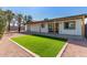 Backyard with artificial turf and covered patio at 1413 N Sunview Pkwy, Gilbert, AZ 85234