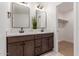 Modern bathroom with dual vanity, stylish mirrors, and walk-in shower at 1413 N Sunview Pkwy, Gilbert, AZ 85234