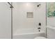 Clean bathroom with white subway tile and bathtub at 1413 N Sunview Pkwy, Gilbert, AZ 85234