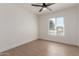 Bright bedroom with wood-look flooring and ceiling fan at 1413 N Sunview Pkwy, Gilbert, AZ 85234