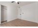 Well-lit bedroom with ceiling fan and spacious closet at 1413 N Sunview Pkwy, Gilbert, AZ 85234