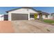 Updated home exterior boasts a modern gray garage door and a bright yellow front door at 1413 N Sunview Pkwy, Gilbert, AZ 85234