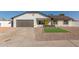 Charming single story home with gray garage door and yellow front door at 1413 N Sunview Pkwy, Gilbert, AZ 85234