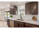 Kitchen with stainless steel dishwasher and white quartz countertops at 1413 N Sunview Pkwy, Gilbert, AZ 85234