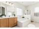 Elegant bathroom featuring a soaking tub and a walk-in shower at 15446 W Montecito Ave, Goodyear, AZ 85395