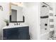 Stylish bathroom with a navy vanity and hexagon tile at 15446 W Montecito Ave, Goodyear, AZ 85395