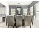 Formal dining room with a large table, gray chairs, and modern chandelier at 15446 W Montecito Ave, Goodyear, AZ 85395