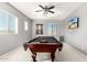 Game room boasts a pool table and ceiling fan at 15446 W Montecito Ave, Goodyear, AZ 85395