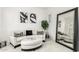 Living room features a white couch and large mirror at 15446 W Montecito Ave, Goodyear, AZ 85395