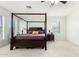 Main bedroom with a four-poster bed and ceiling fan at 15446 W Montecito Ave, Goodyear, AZ 85395