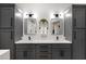 Modern double vanity bathroom with gray cabinets and mirrors at 15632 S 6Th St, Phoenix, AZ 85048