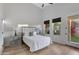 Main bedroom with gray dresser, ensuite bathroom, and large TV at 15632 S 6Th St, Phoenix, AZ 85048