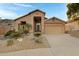 Tan stucco home with desert landscaping and a two-car garage at 15632 S 6Th St, Phoenix, AZ 85048