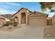 Tan stucco home with desert landscaping and a two-car garage at 15632 S 6Th St, Phoenix, AZ 85048