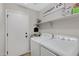 Convenient laundry room with washer, dryer, and shelving at 15632 S 6Th St, Phoenix, AZ 85048