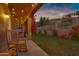 Charming patio with rocking chairs and string lights, overlooking a grassy backyard at 15632 S 6Th St, Phoenix, AZ 85048