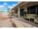 Backyard featuring a covered patio with furniture, desert landscape, and decorative rocks at 15738 W Clear Canyon Dr, Surprise, AZ 85374