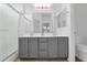 This bathroom features a shower and a double sink vanity with gray cabinetry at 15738 W Clear Canyon Dr, Surprise, AZ 85374