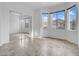 Bedroom featuring neutral tile floors, sliding mirror closet doors, and large windows at 15738 W Clear Canyon Dr, Surprise, AZ 85374