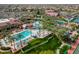 Aerial view of resort-style community pool surrounded by palm trees and well-manicured landscaping at 15738 W Clear Canyon Dr, Surprise, AZ 85374