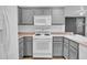 This well-lit kitchen features stainless appliances, white cabinetry, and neutral countertops at 15738 W Clear Canyon Dr, Surprise, AZ 85374