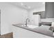 This well-lit kitchen features stainless appliances, white cabinetry, and neutral countertops at 15738 W Clear Canyon Dr, Surprise, AZ 85374