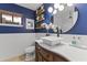 Modern bathroom with a white vessel sink and blue walls at 15801 N 51St St, Scottsdale, AZ 85254