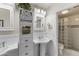 Elegant bathroom with pedestal sinks and glass-block shower at 15801 N 51St St, Scottsdale, AZ 85254