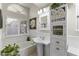 Classic bathroom with white cabinets, pedestal sink, and soaking tub at 15801 N 51St St, Scottsdale, AZ 85254