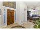 Bright entryway with a wood door and views to the office and living areas at 15801 N 51St St, Scottsdale, AZ 85254