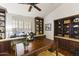 Bright home office features built-in shelving and hardwood floors at 15801 N 51St St, Scottsdale, AZ 85254