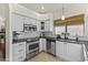 White cabinets, granite counters, and stainless steel appliances in a corner kitchen at 15801 N 51St St, Scottsdale, AZ 85254