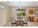 Bright dining area with glass table and chairs, adjacent to kitchen at 16220 W Red Rock Dr, Surprise, AZ 85374