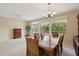 Dining room with a wooden table, chairs, and view to the backyard at 16220 W Red Rock Dr, Surprise, AZ 85374