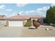 Single-story home with a two-car garage and manicured landscaping at 16220 W Red Rock Dr, Surprise, AZ 85374