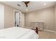 Neutral bedroom featuring a white dresser, ceiling fan, and ensuite bathroom access at 16639 W Pinchot Ave, Goodyear, AZ 85395