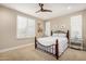 Cozy bedroom with a wrought iron bed frame, plantation shutters, and neutral carpet at 16639 W Pinchot Ave, Goodyear, AZ 85395