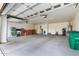 Spacious garage with ample storage and a white door leading to the house at 16639 W Pinchot Ave, Goodyear, AZ 85395